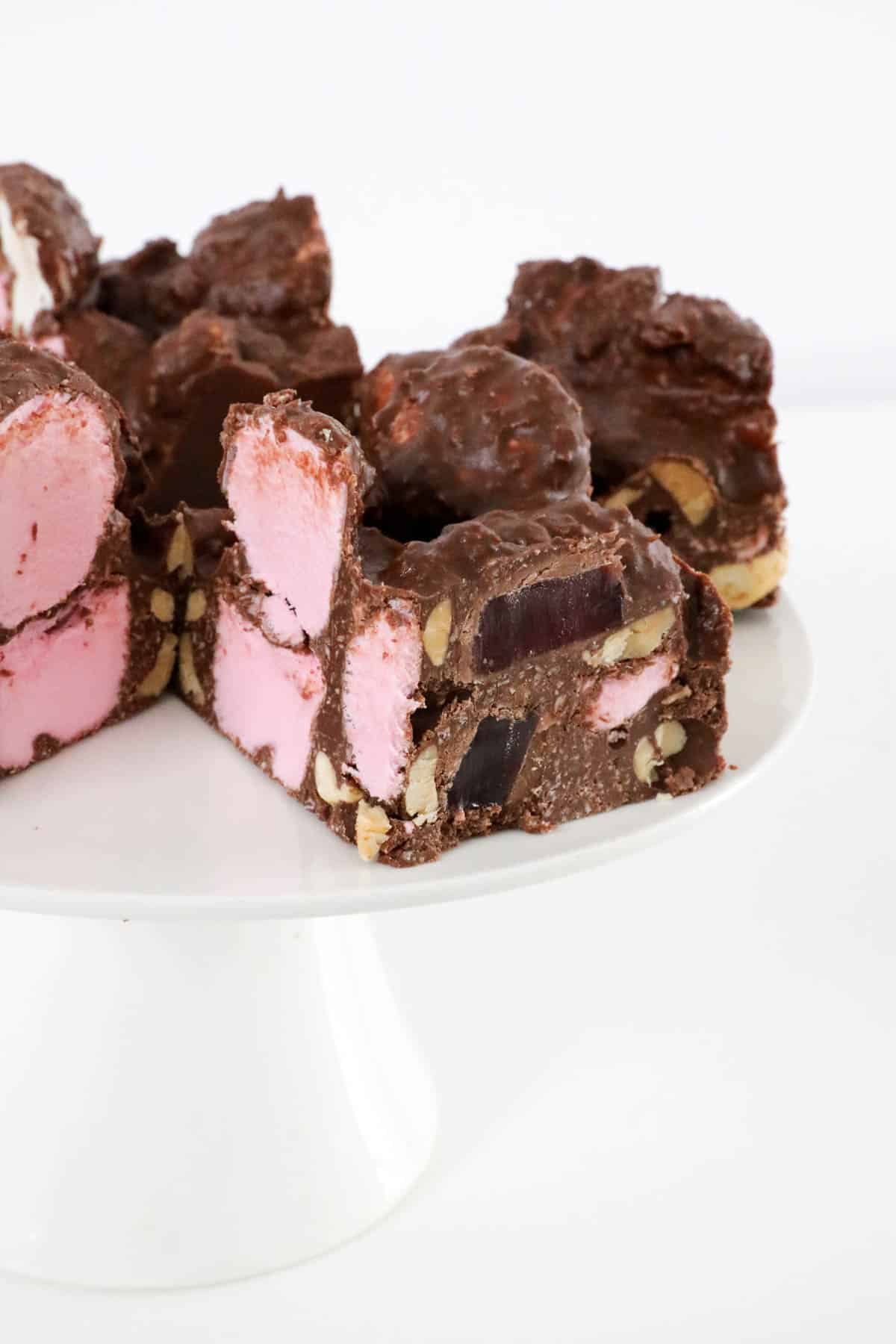Pieces of rocky road on a cake stand.