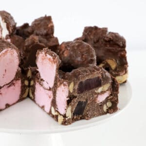 Pieces of rocky road on a cake stand.