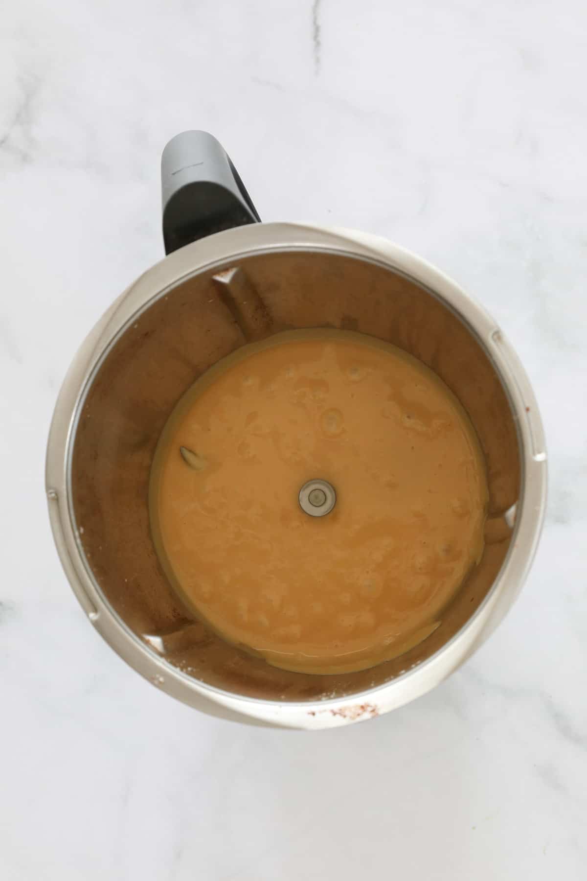 Hot fudge liquid in a Thermomix bowl.