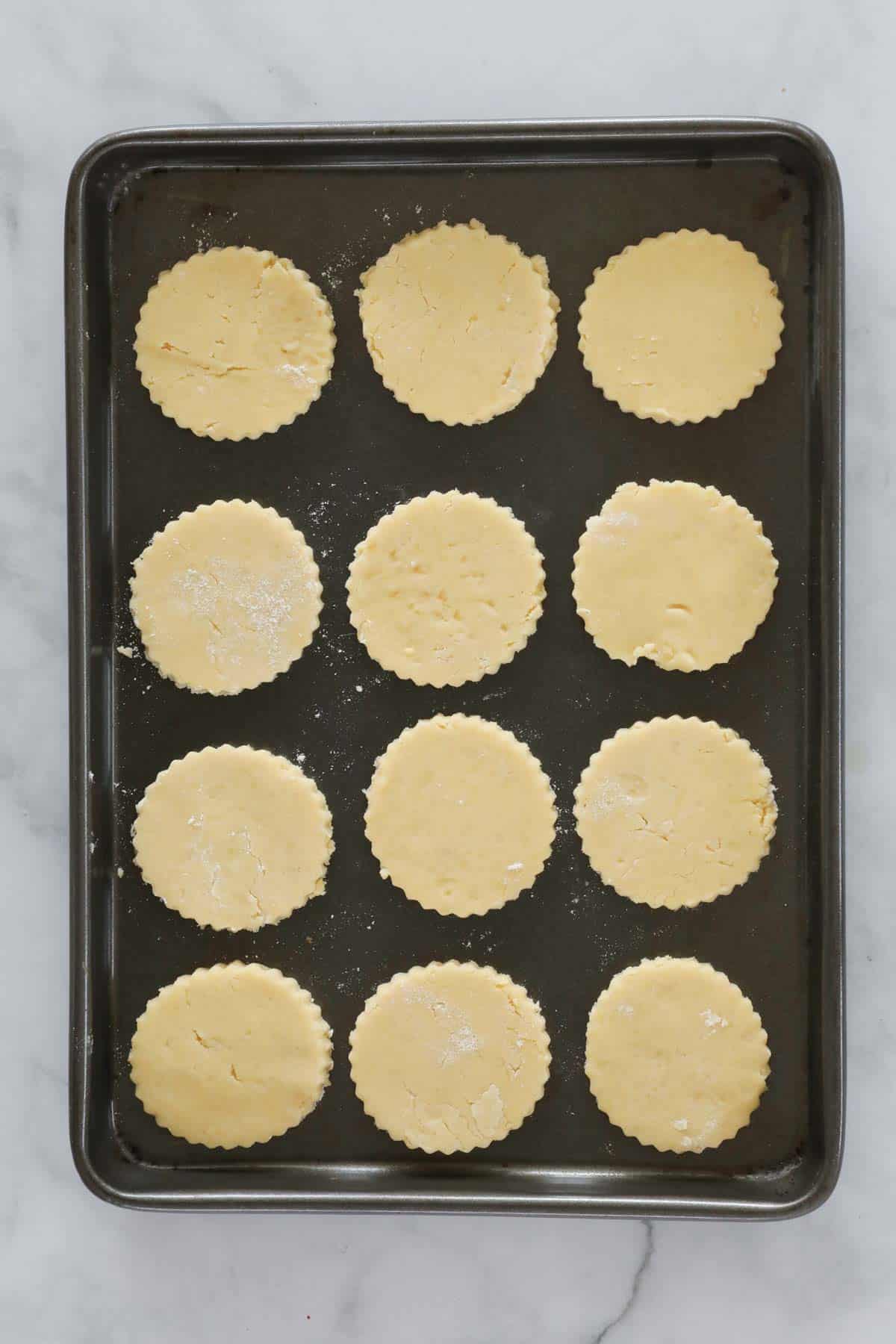 Round cookies on a baking tray.