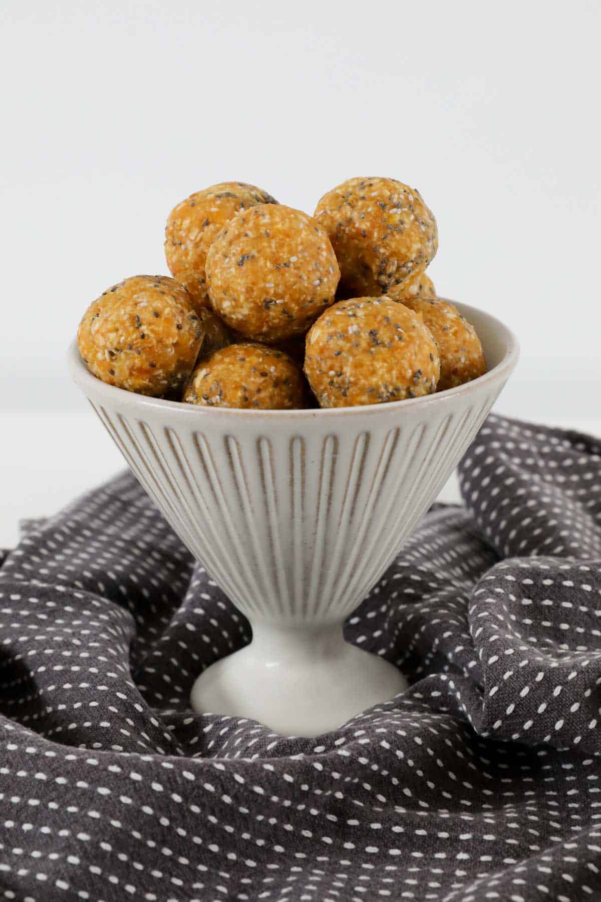 A bowl filled with apricot oat bliss balls.