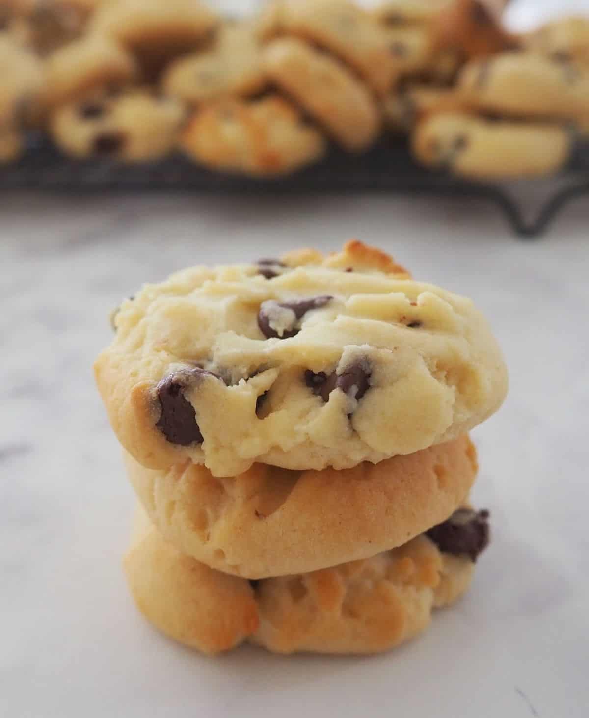 Close up of three condensed milk biscuits with chocolate chips.