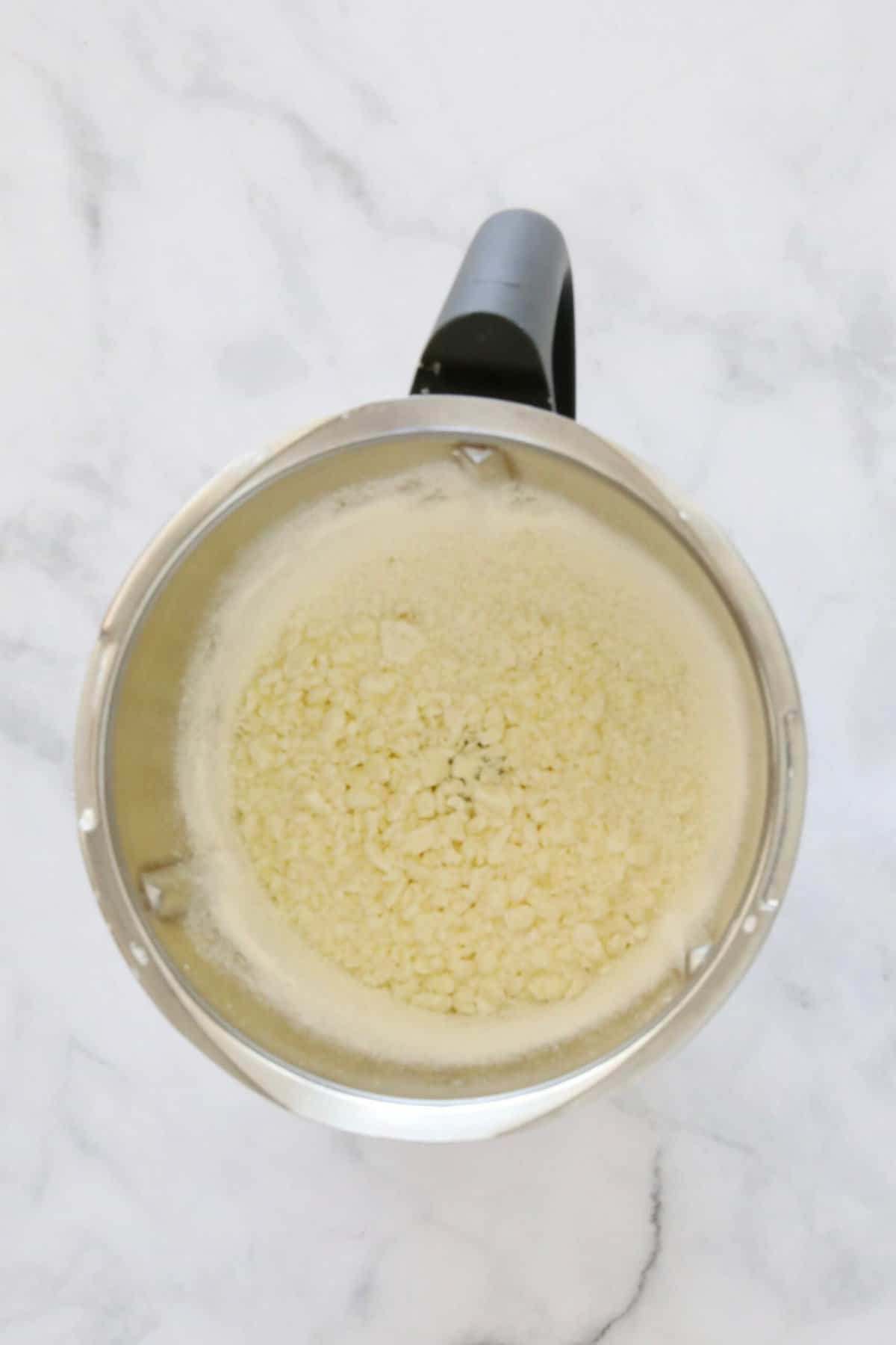 Grated white chocolate in a Thermomix.