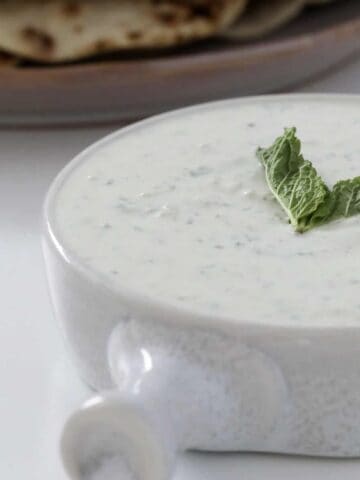 A bowl of mint and cucumber raita dip made in a Thermomix.