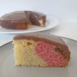 Slice of Marble cake on a grey plate.