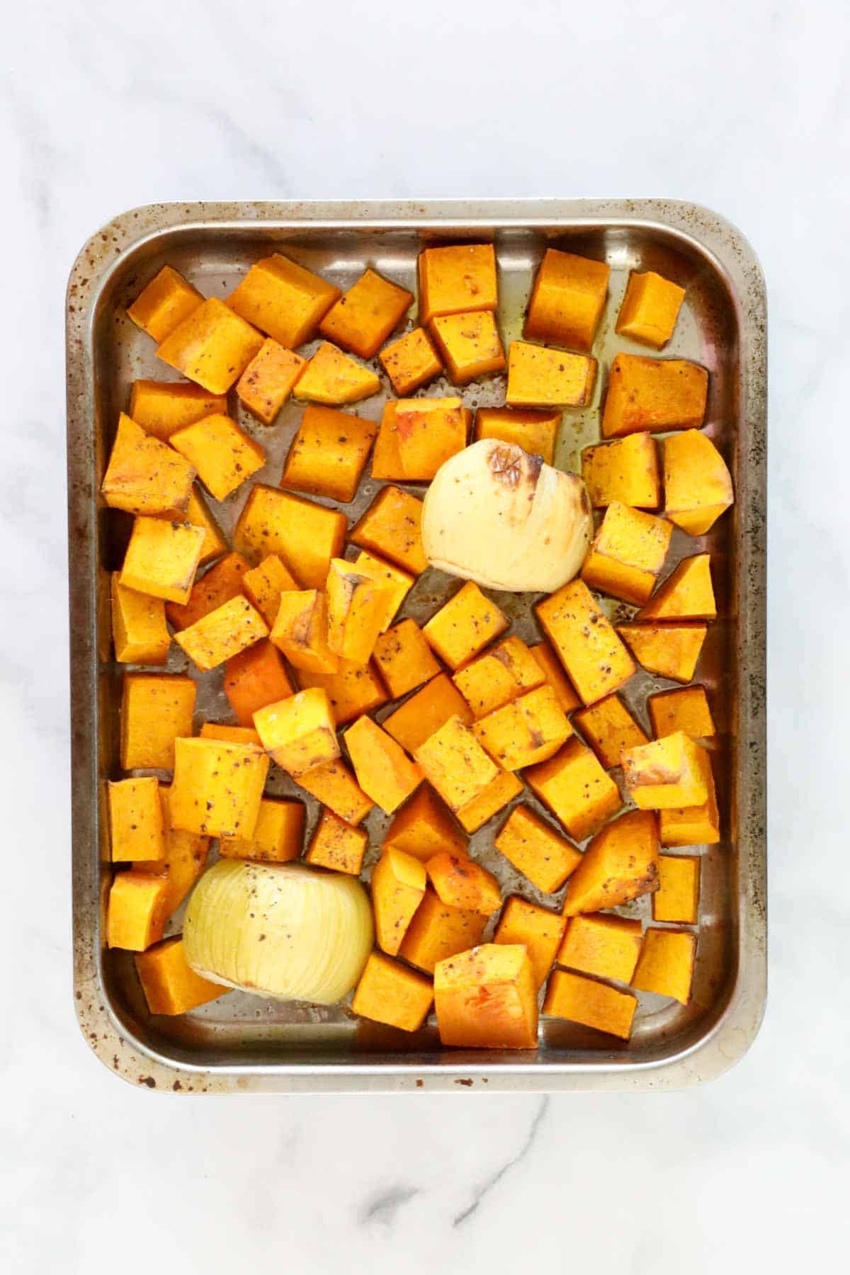 A tray of roasted pumpkin and onion.