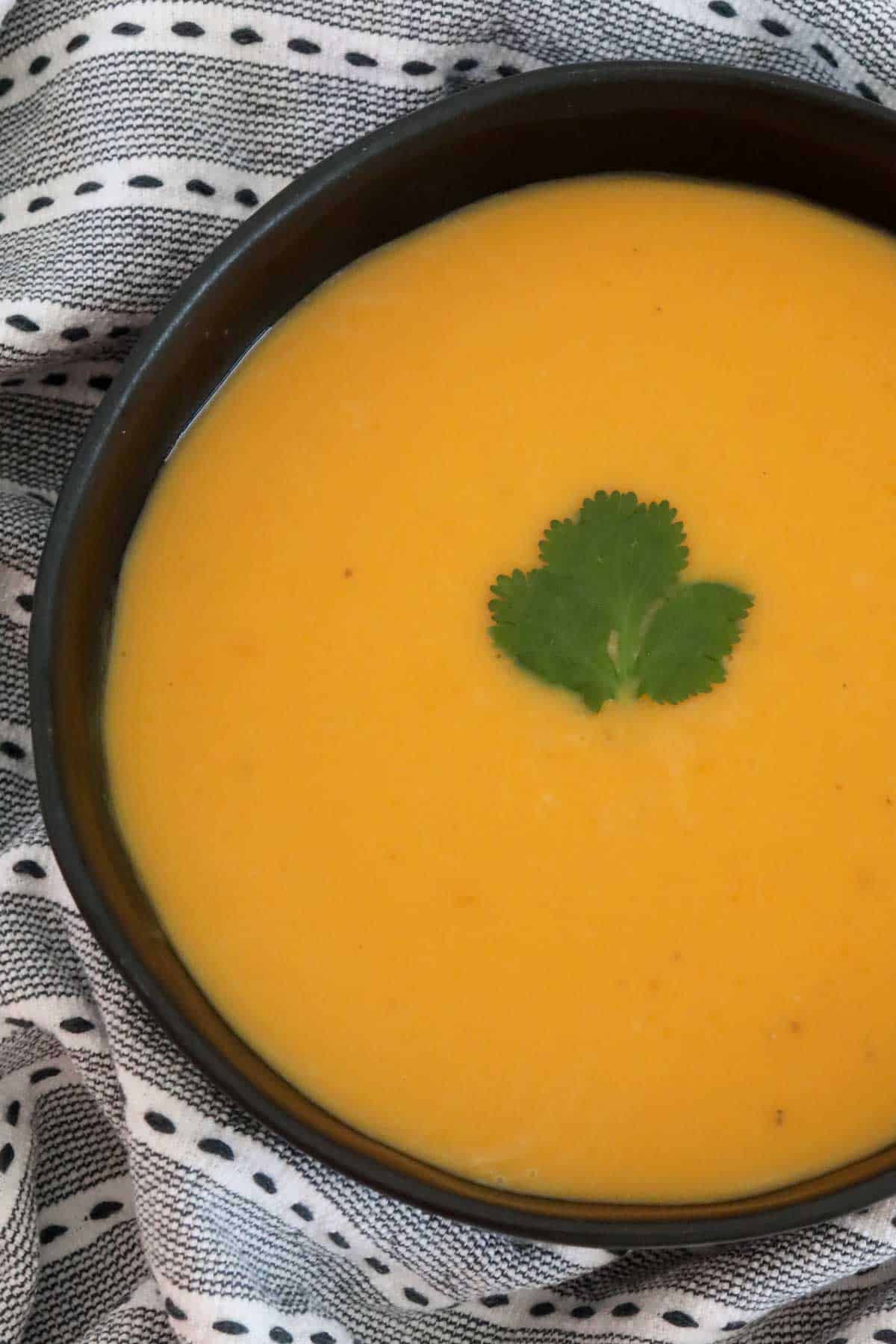 An overhead shot of a bowl of pumpkin soup.