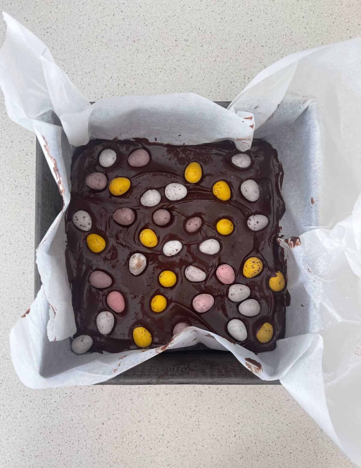 Easter egg brownie mixture in a baking tin ready to go into the oven.