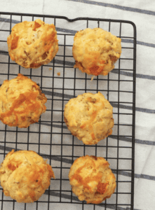 Ham Cheese and Tomato Muffins on a wire rack.