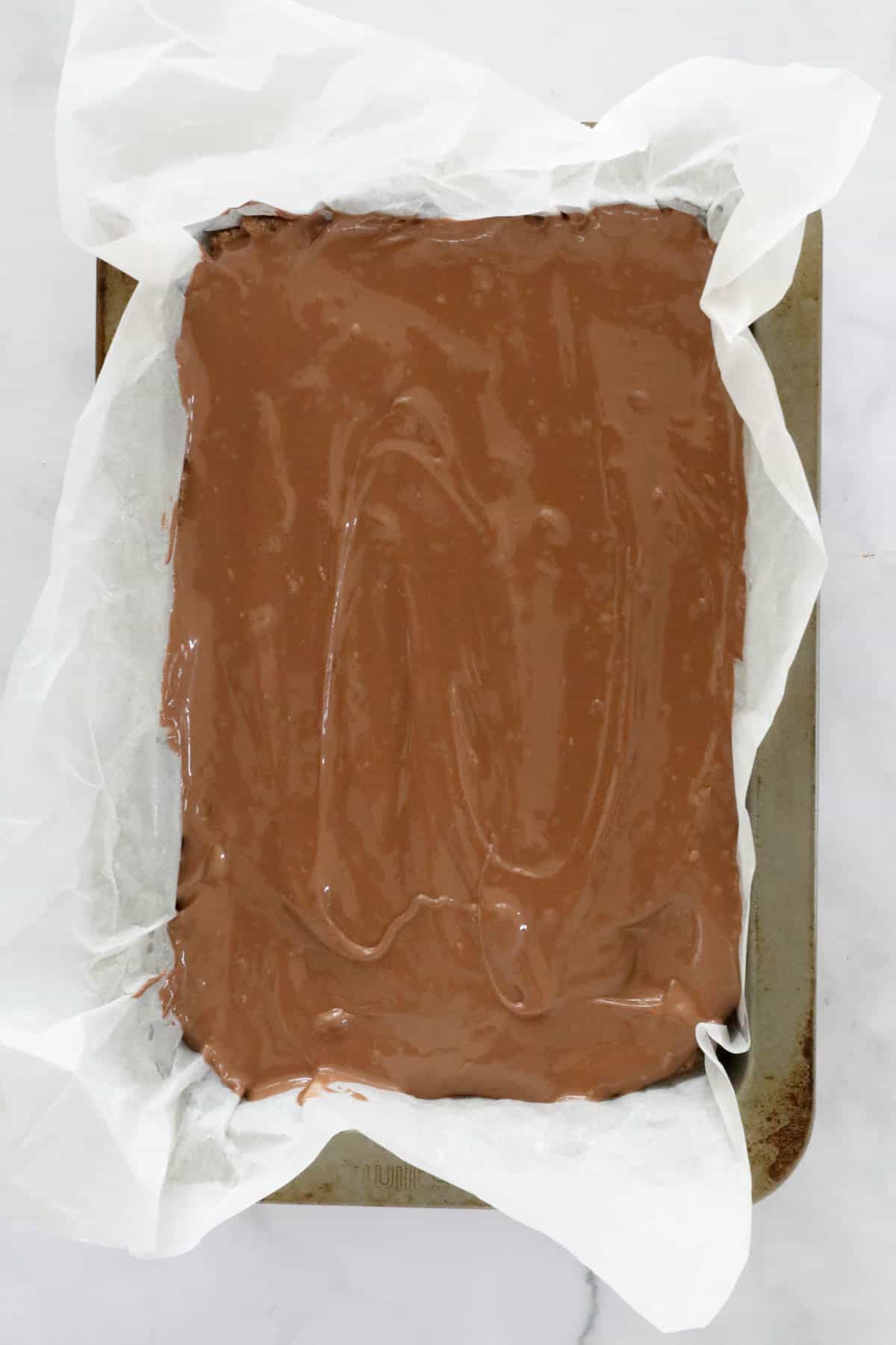 An overhead shot of chocolate topped slice.
