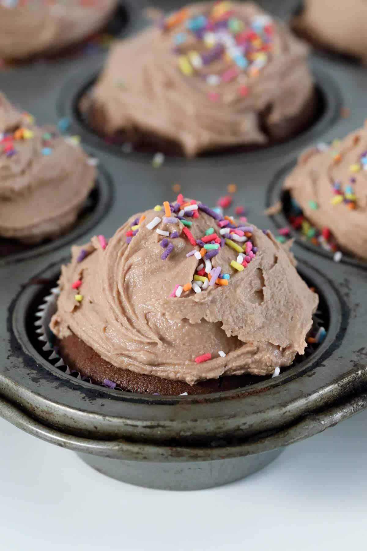 A chocolate frosted cupcake.