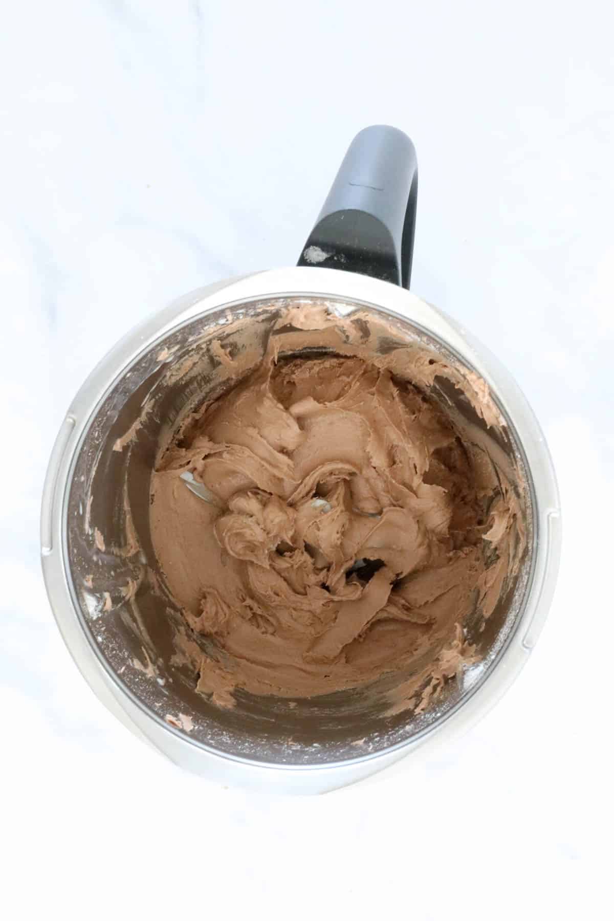 Chocolate frosting in a Thermomix bowl.