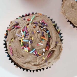 An overhead shot of chocolate cupcakes with frosting.