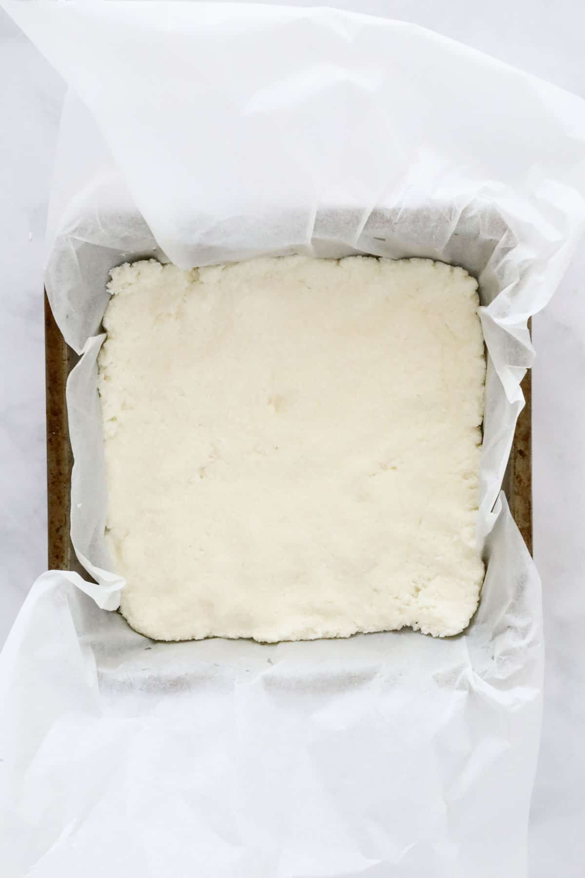 White coconut mixture in a baking tin.