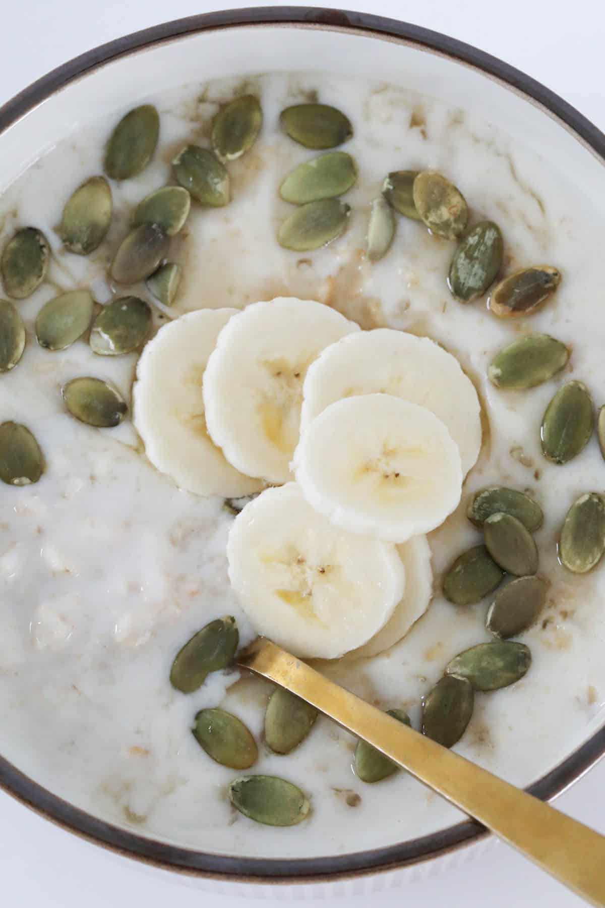 Banana and seeds on top of porridge.