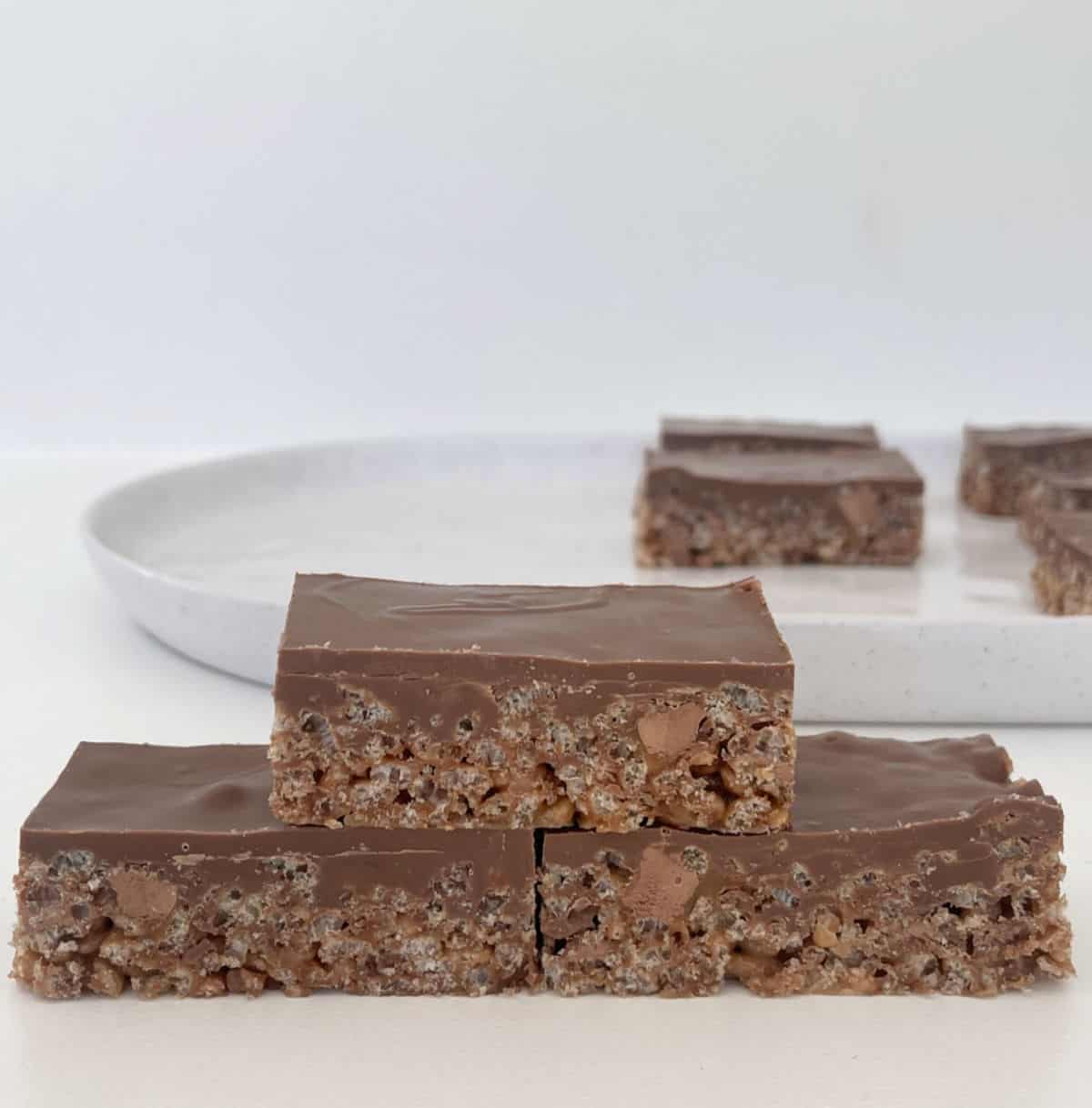 Three pieces of Mars Bar Slice sitting on top of each other.