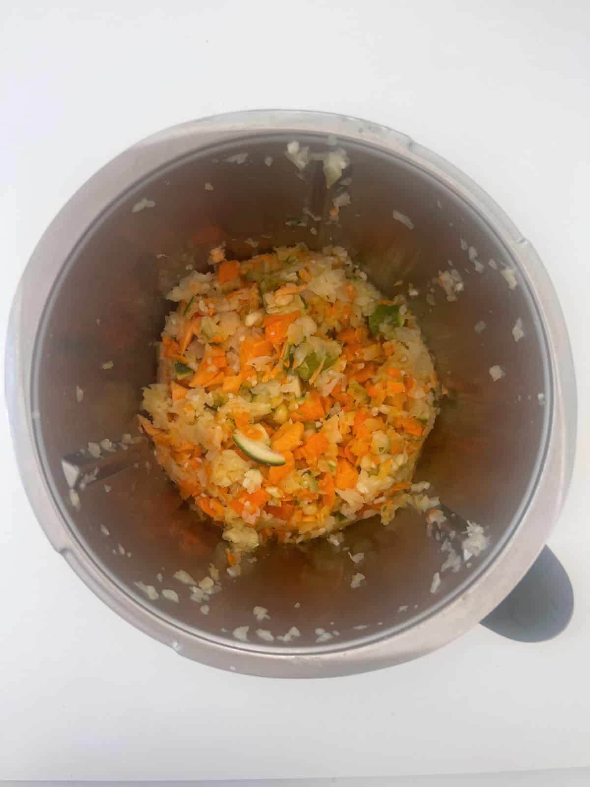 Diced vegetables in a Thermomix bowl that have been cooked.