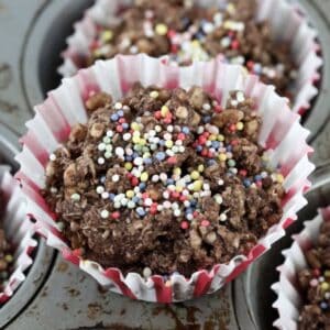 A chocolate crackle on top of a muffin tin.