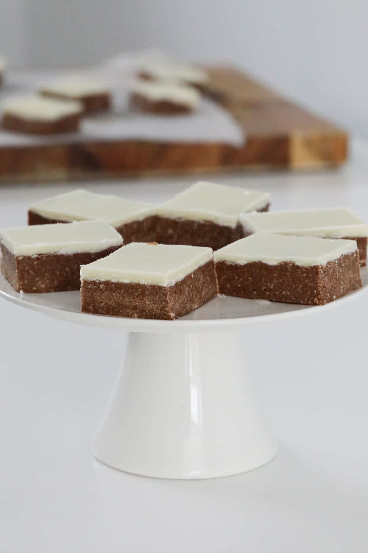 A cake stand of peppermint slice.