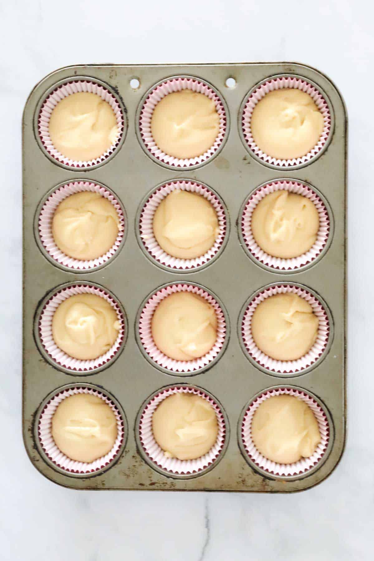 Cupcake mixture in a muffin tin.