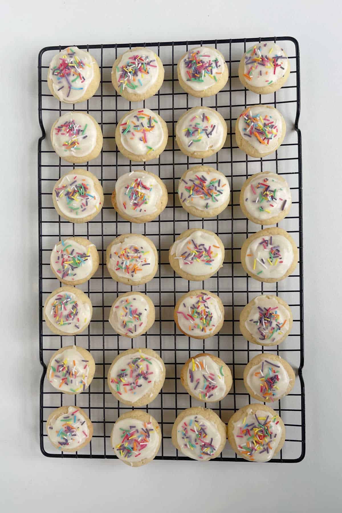 Iced and Decorated Fairy Biscuits on a wire rack.