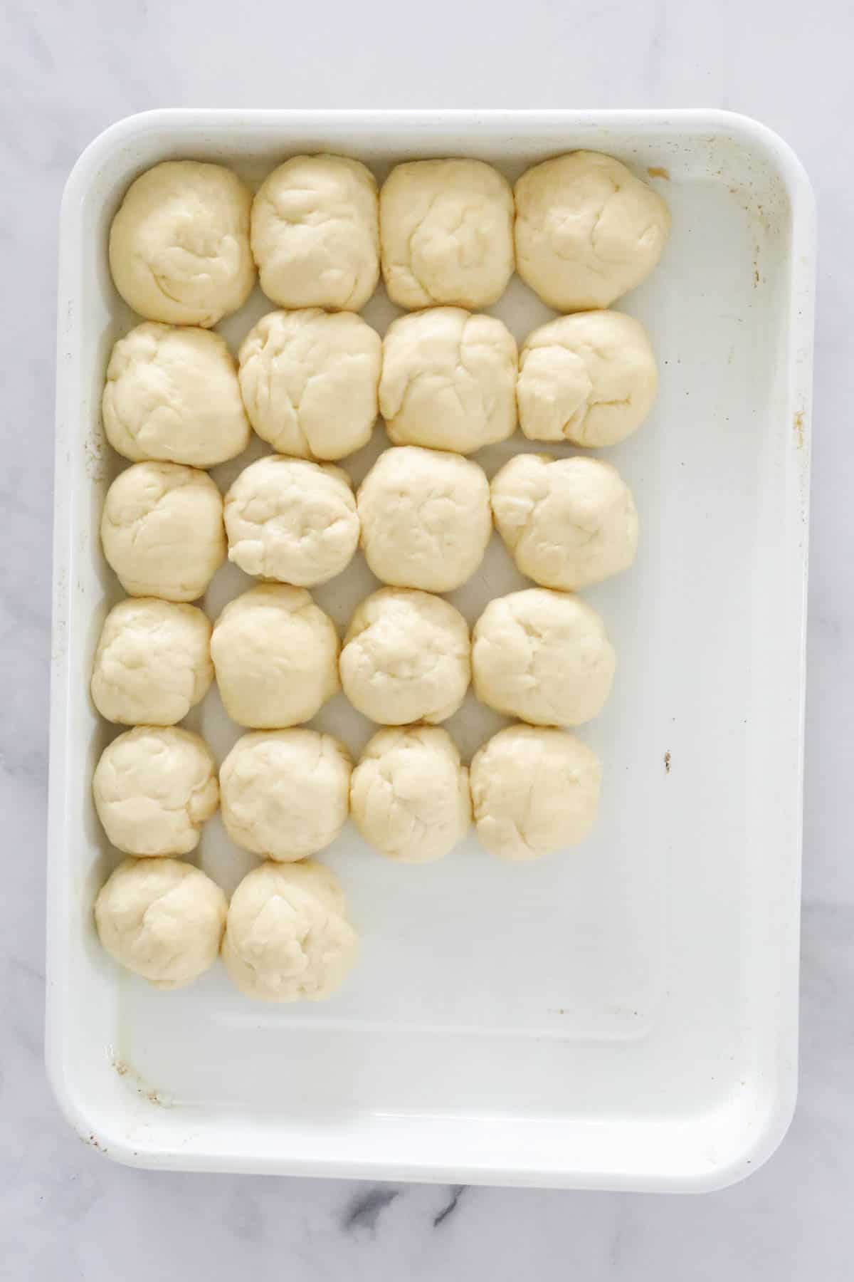 Balls of dough on a baking tray.