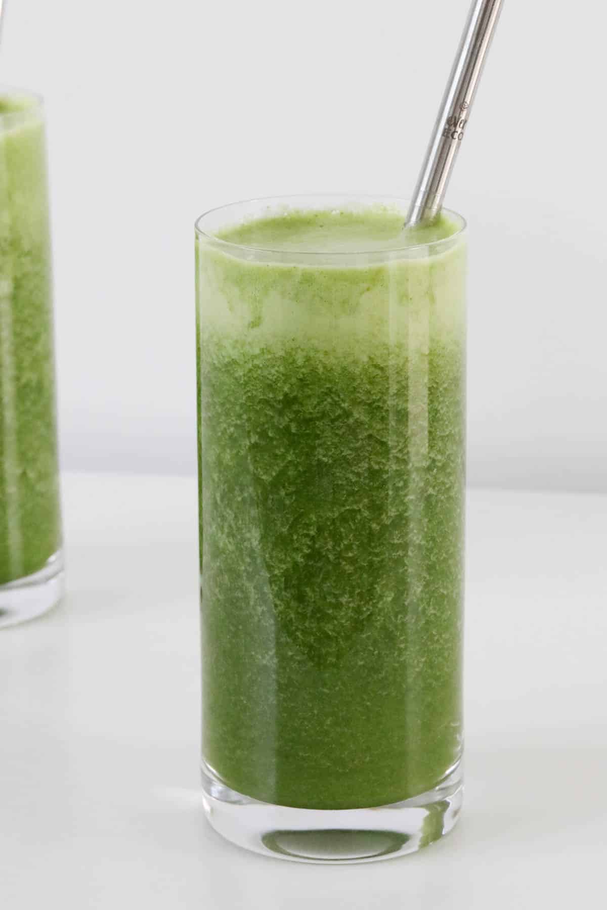 A glass of a green juice.