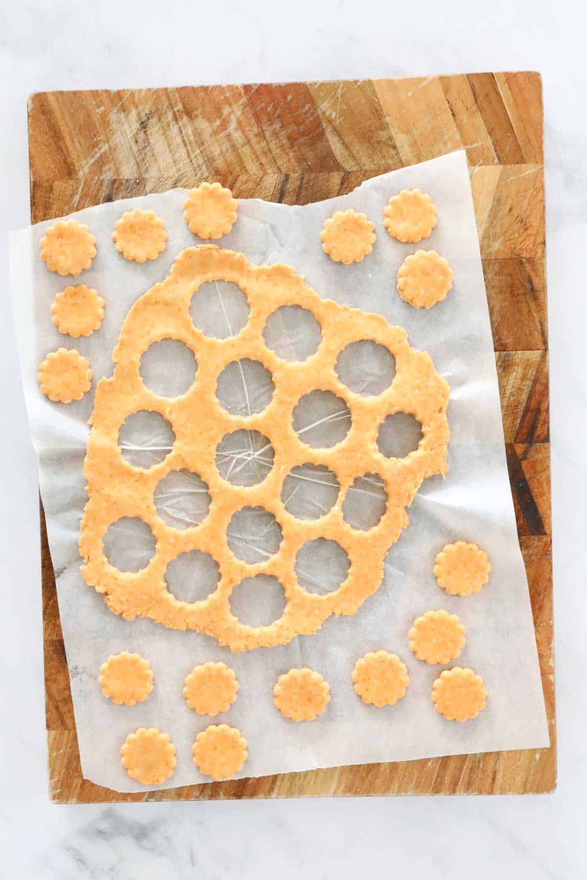 Crackers being cut out from dough.