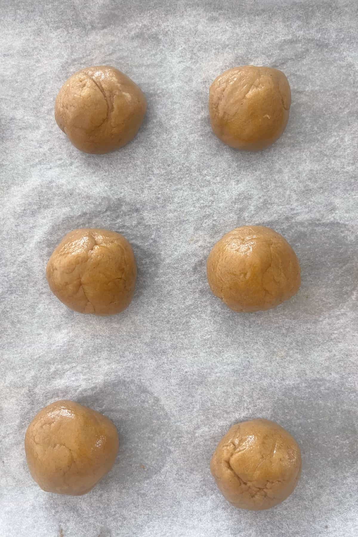 Ginger Biscuit Dough in balls on a baking tray.