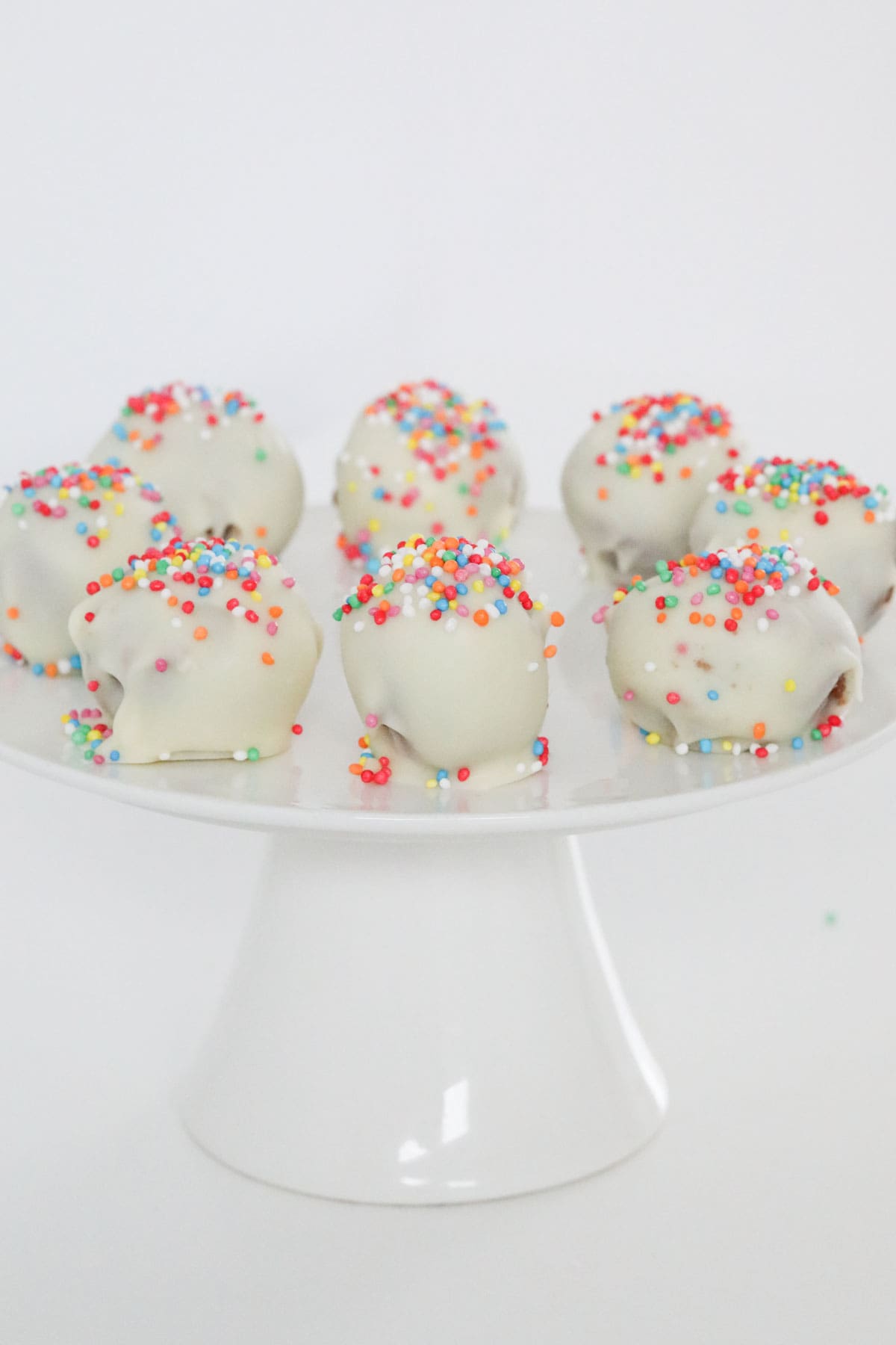 A plate of white chocolate coated dessert balls.
