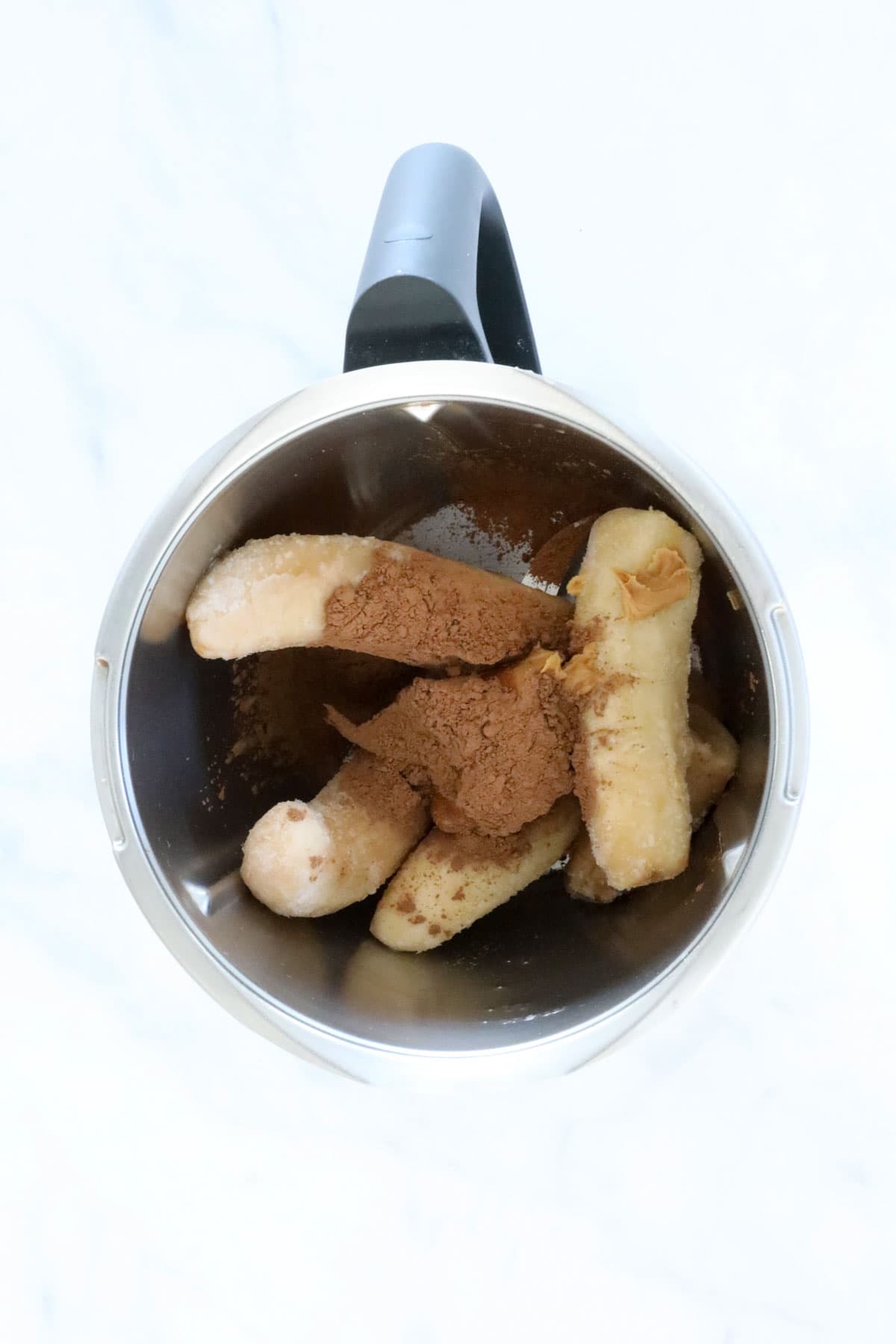 Frozen bananas, cocoa and peanut butter in a Thermomix.