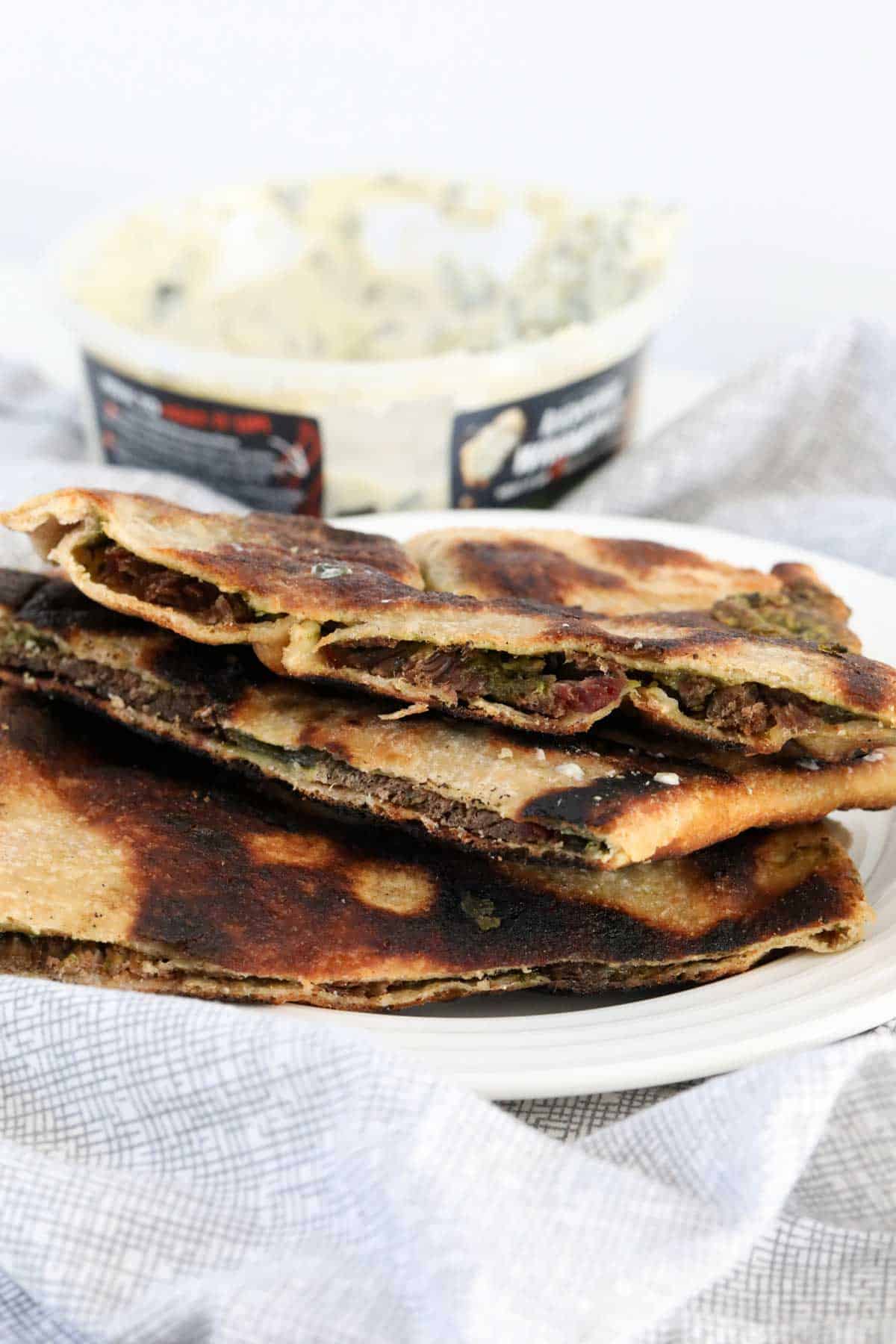 Lamb gozlemes stacked on a plate. 