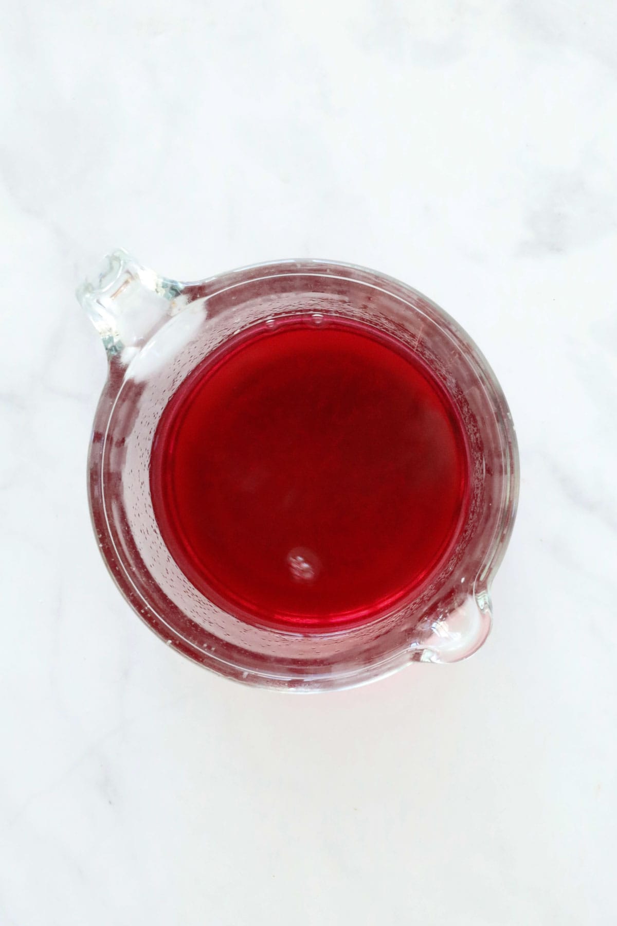 Raspberry jelly in a jug.