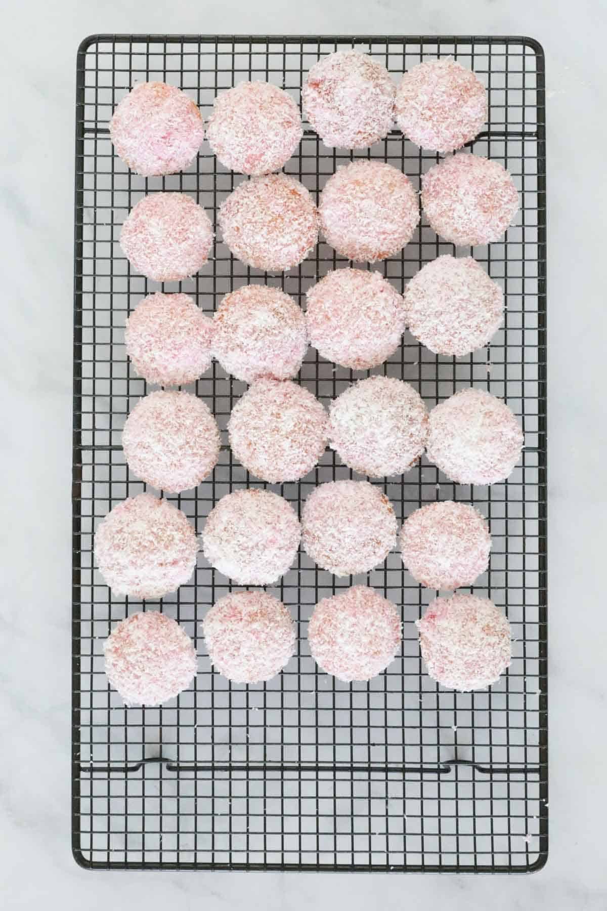 Unfilled jelly cakes on a wire rack.