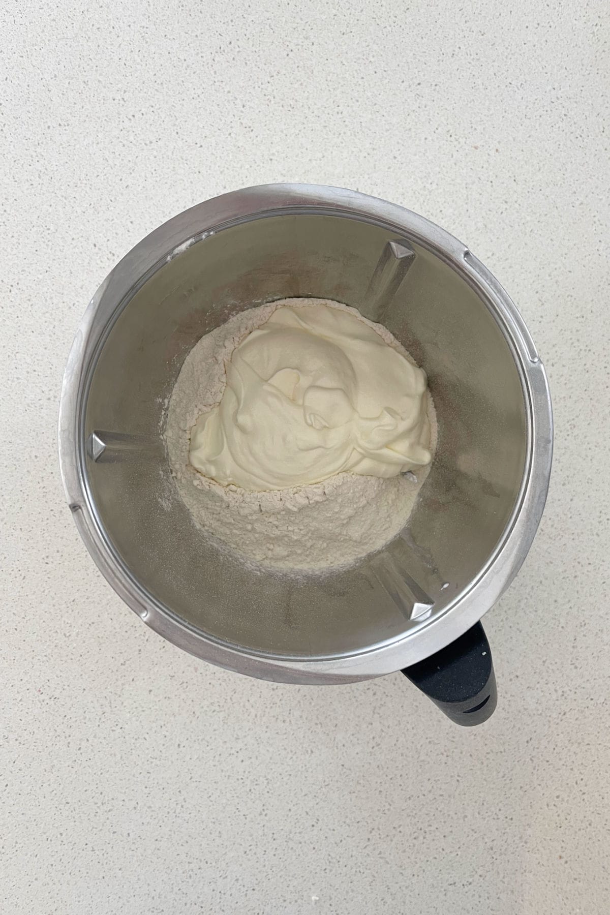 greek yoghurt and self-raising flour inside of a thermomix bowl.