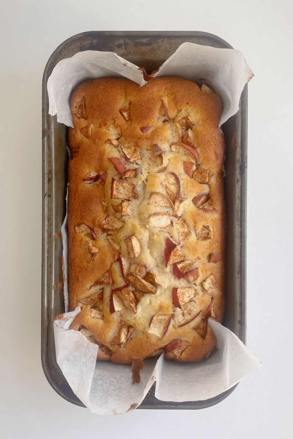 Apple loaf straight from the oven in baking dish.