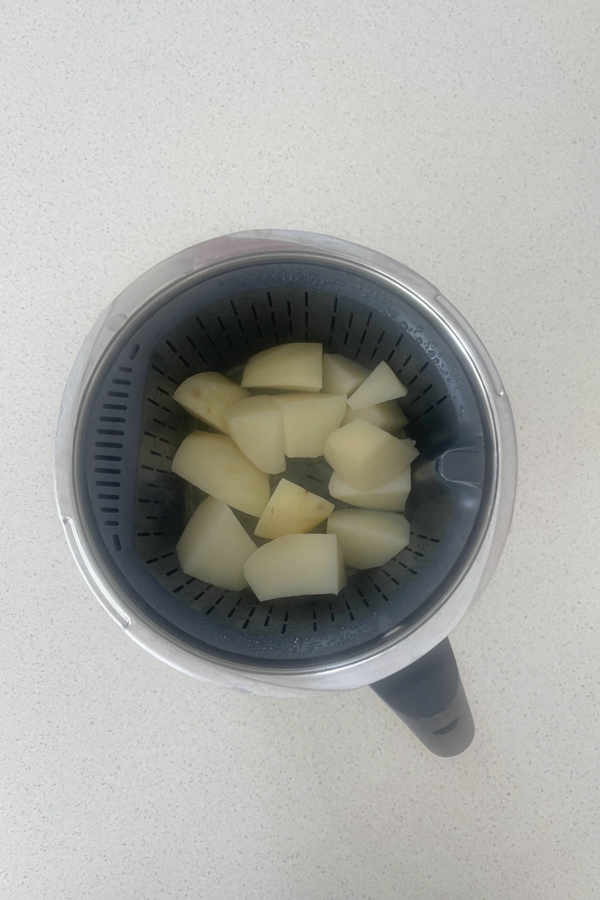 Boiled potatoes inside a thermomix bowl.