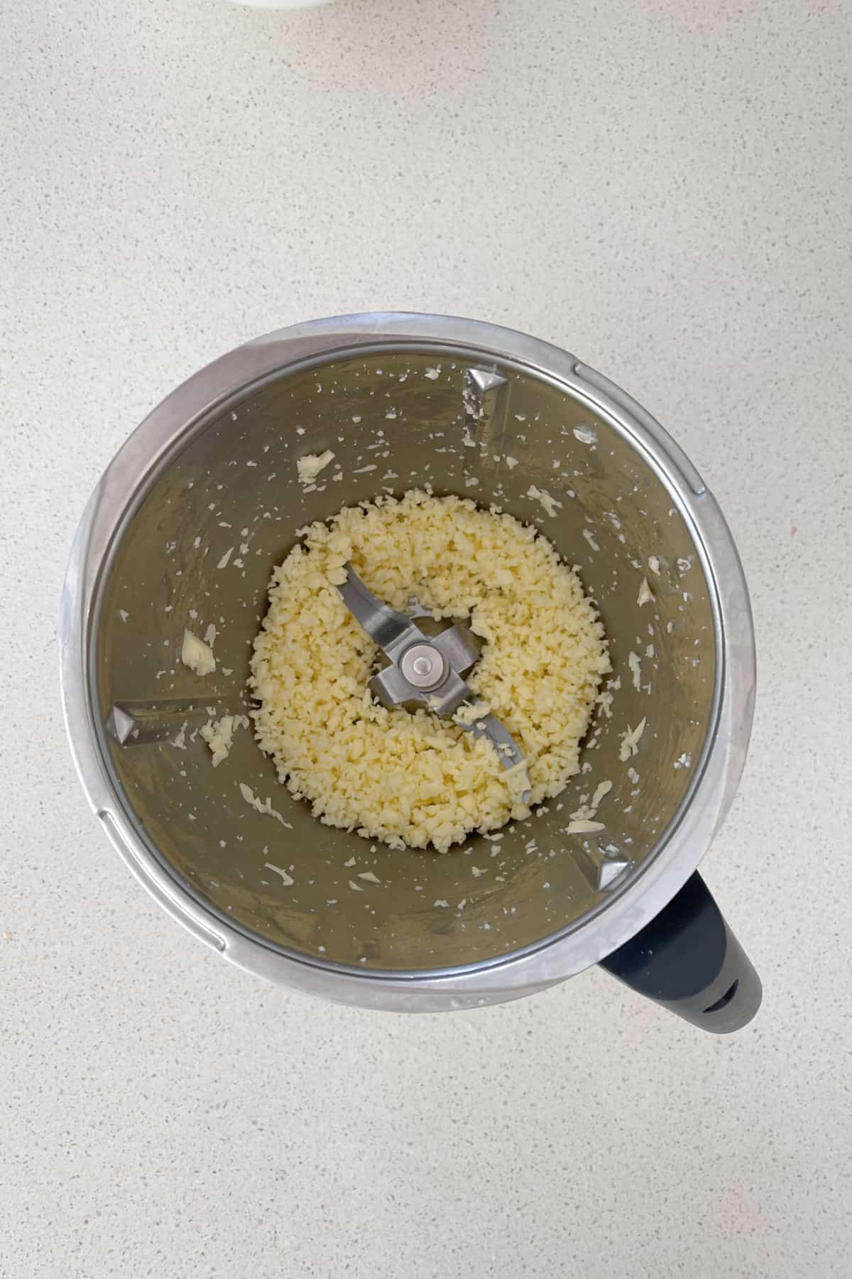 Grated cheese in a Thermomix bowl.
