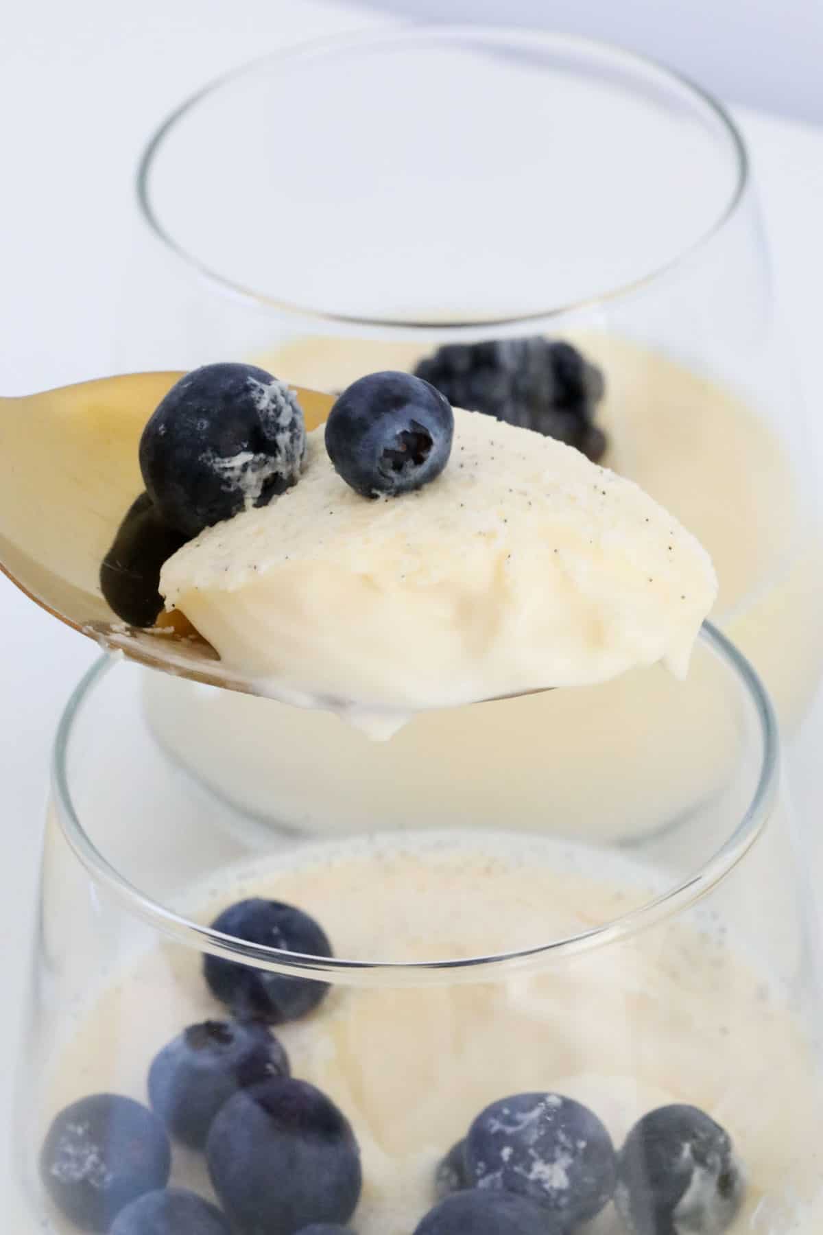 A spoonful of panna cotta and blueberries.