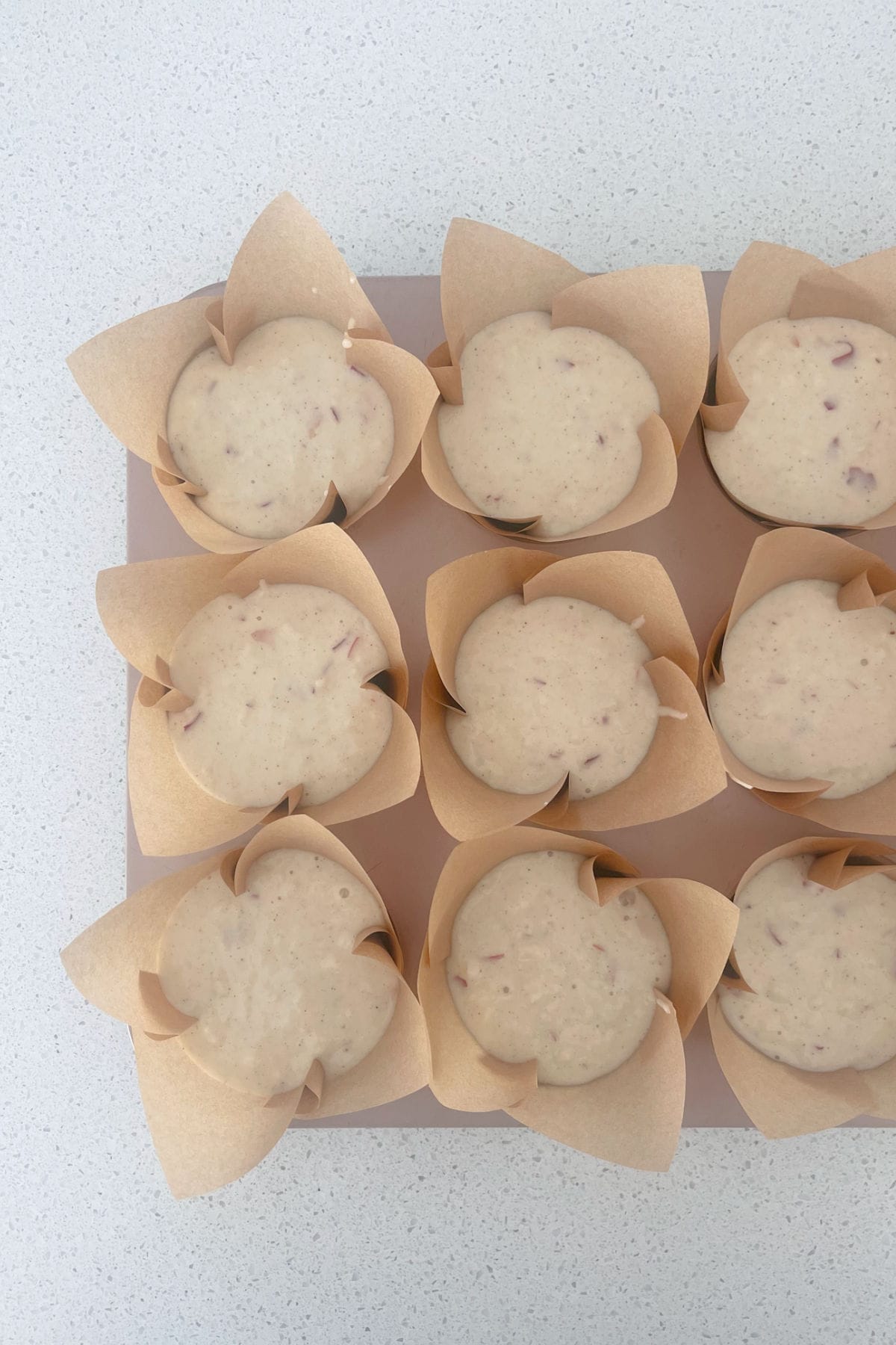 Apple Muffins in paper cases before going into the oven.