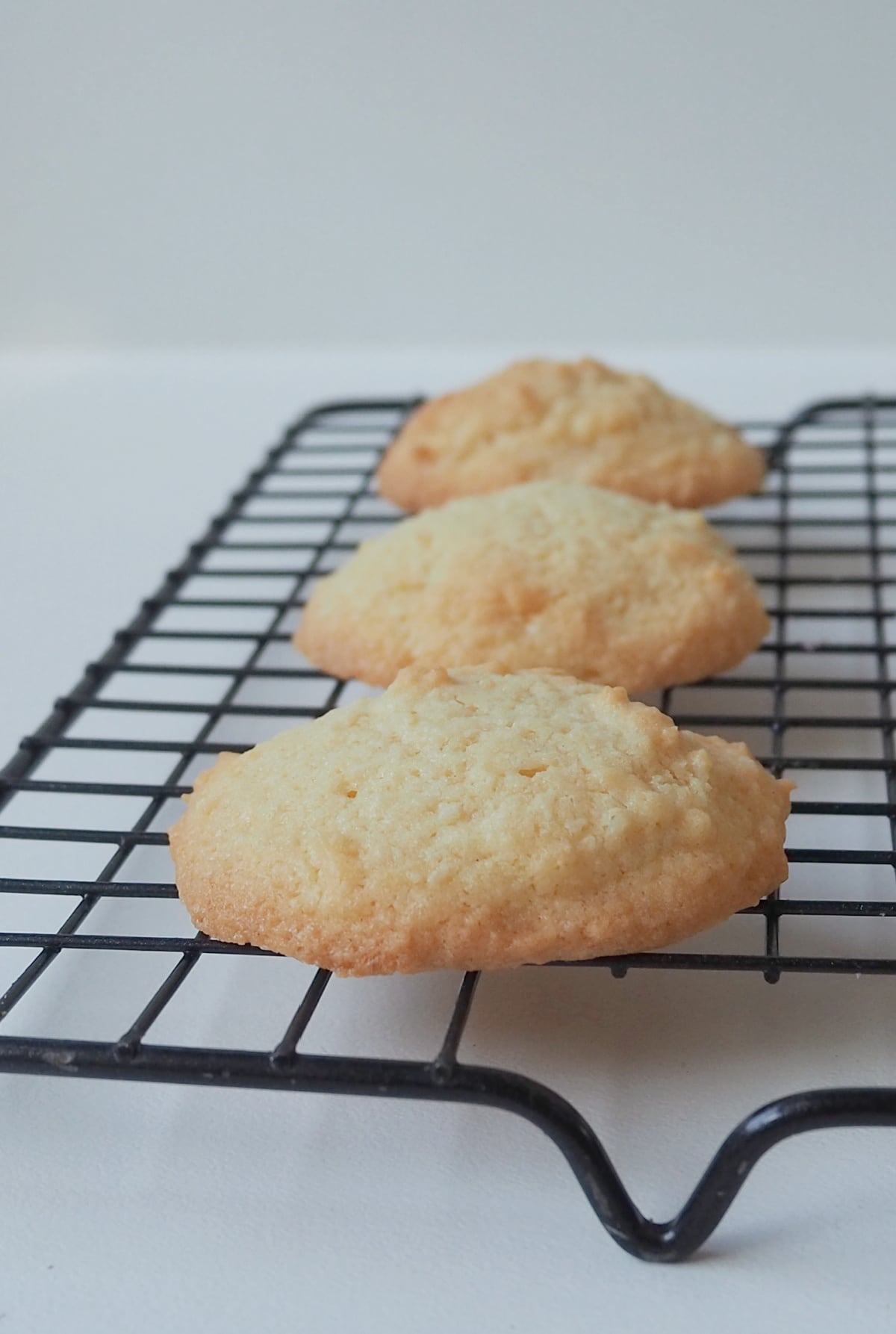 Coconut Biscuits made in a thermion sitting on a wire rack.