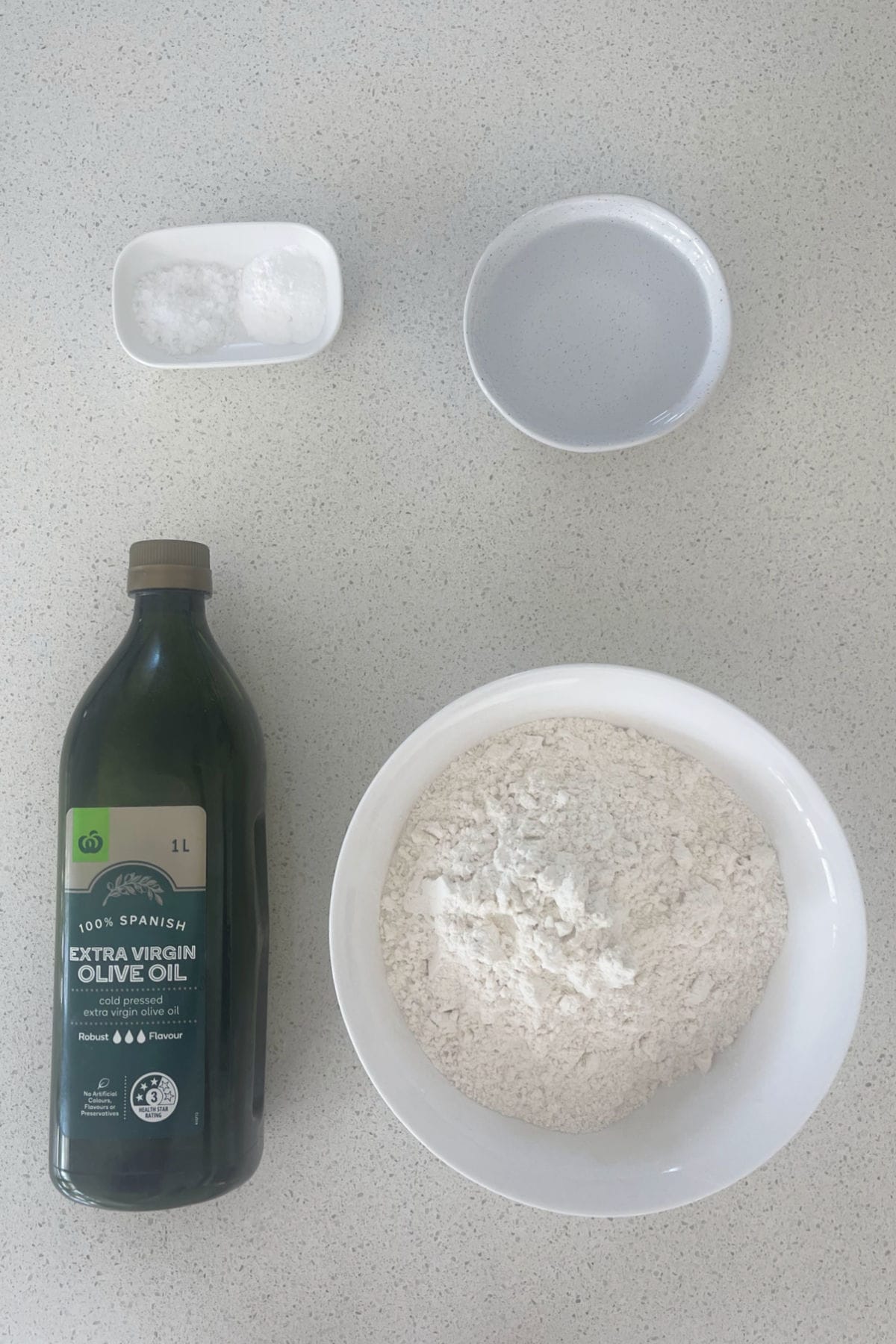 Ingredients to make Tortillas in a thermomix on a speckled bench top.