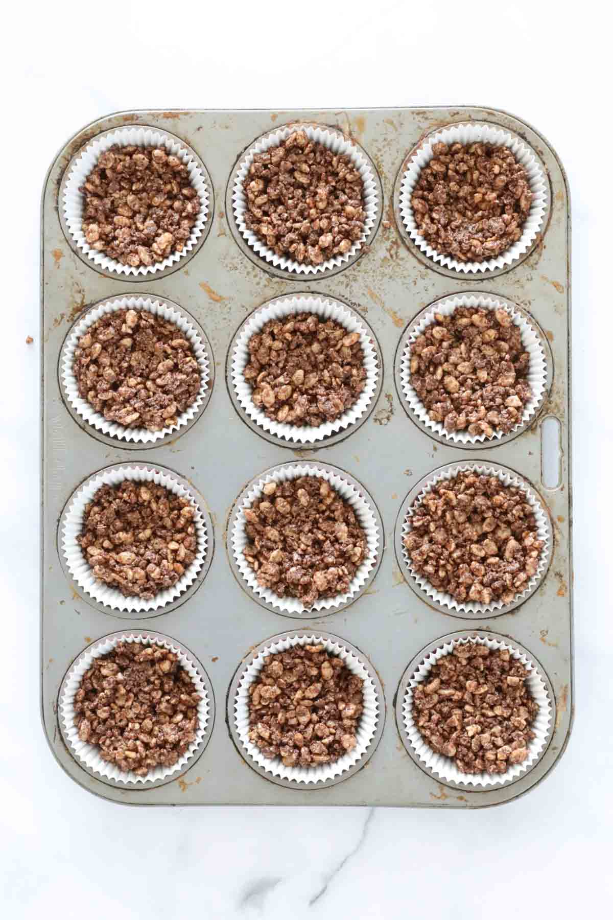 Chocolate crackles in a muffin tin.