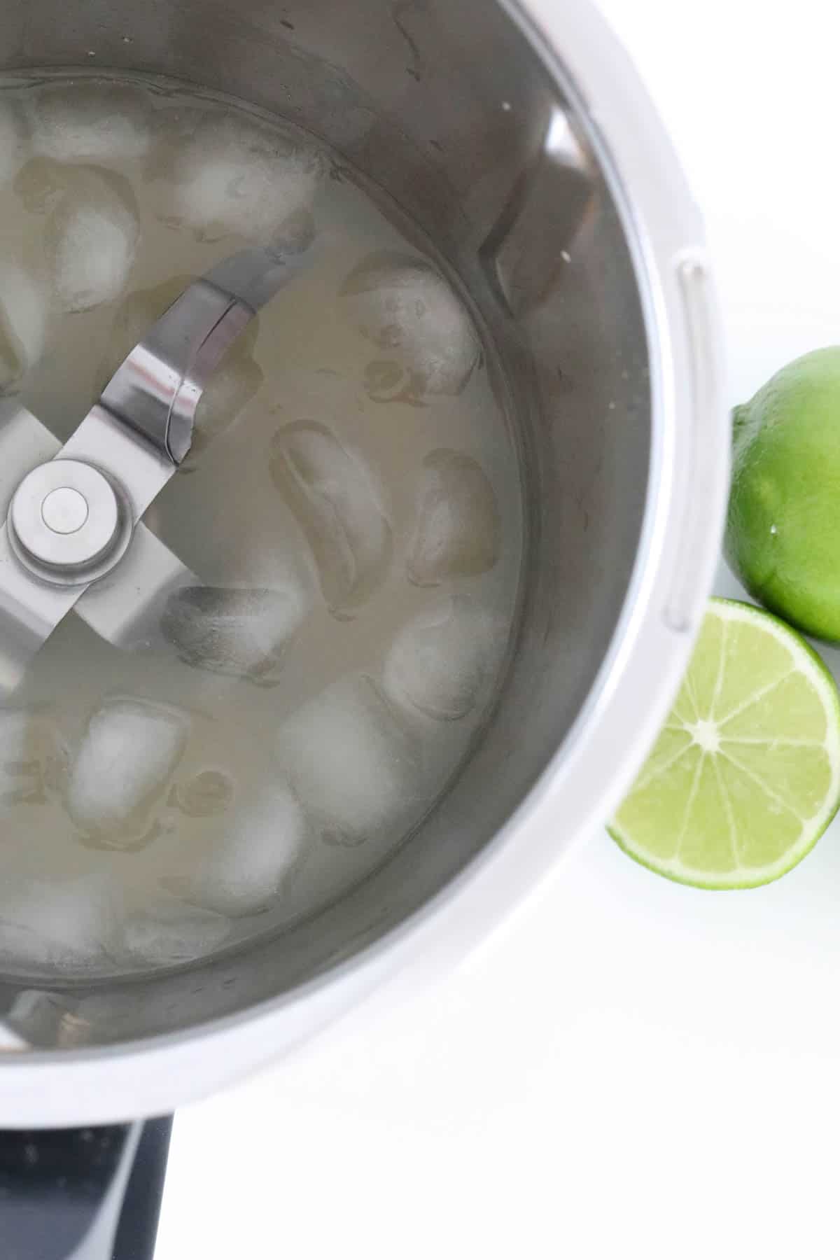 Lime margarita and ice cubes in a Thermomix.