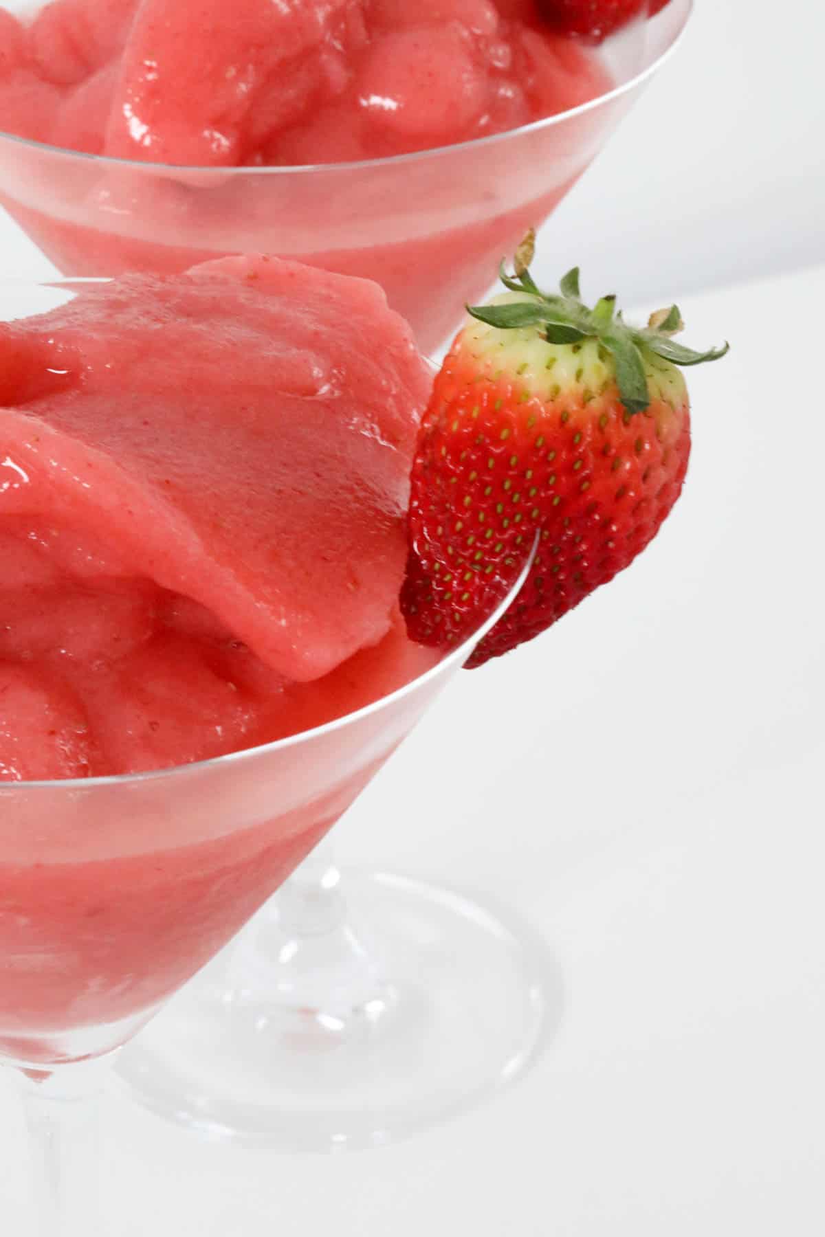 A frozen cocktail with a strawberry.