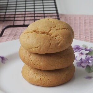 A stack of three Caramel Cookies sitting on a decorative plate with gold edging.
