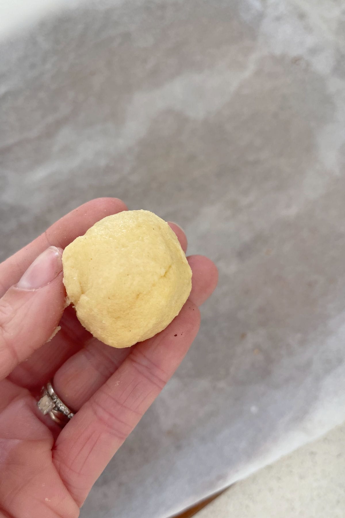Adult holding ball of Christmas Biscuit dough.