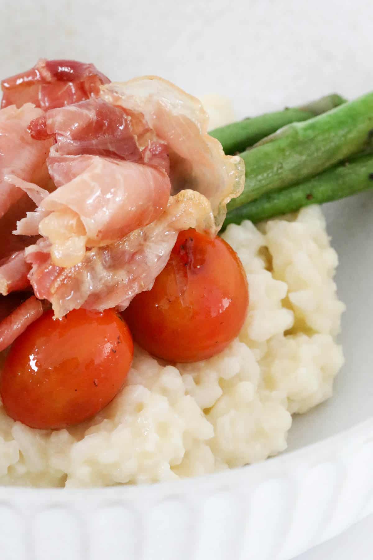 Crispy prosciutto and grilled veggies on top of risotto.