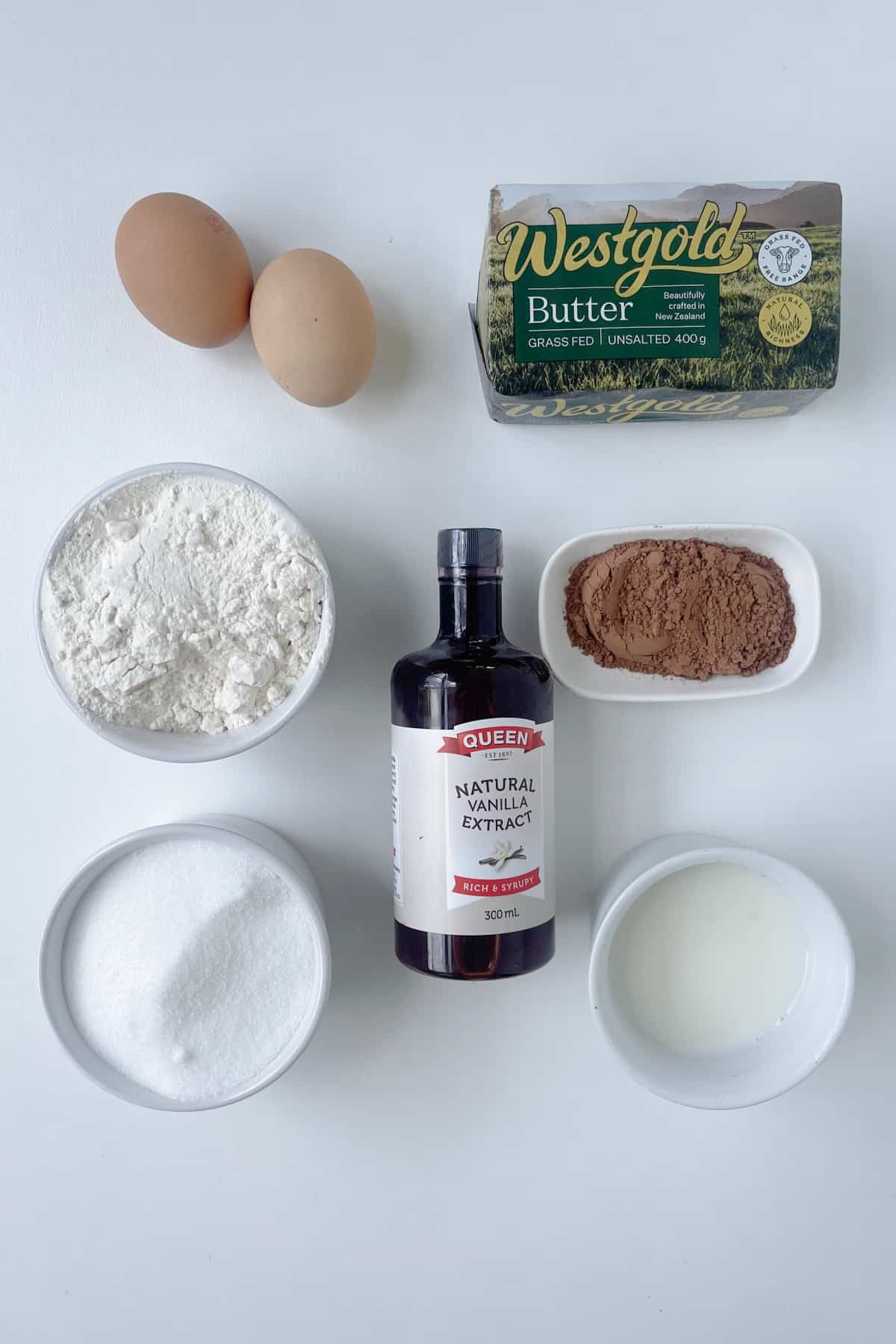 Ingredients to make a chocolate cake in a thermomix on a white bench top.