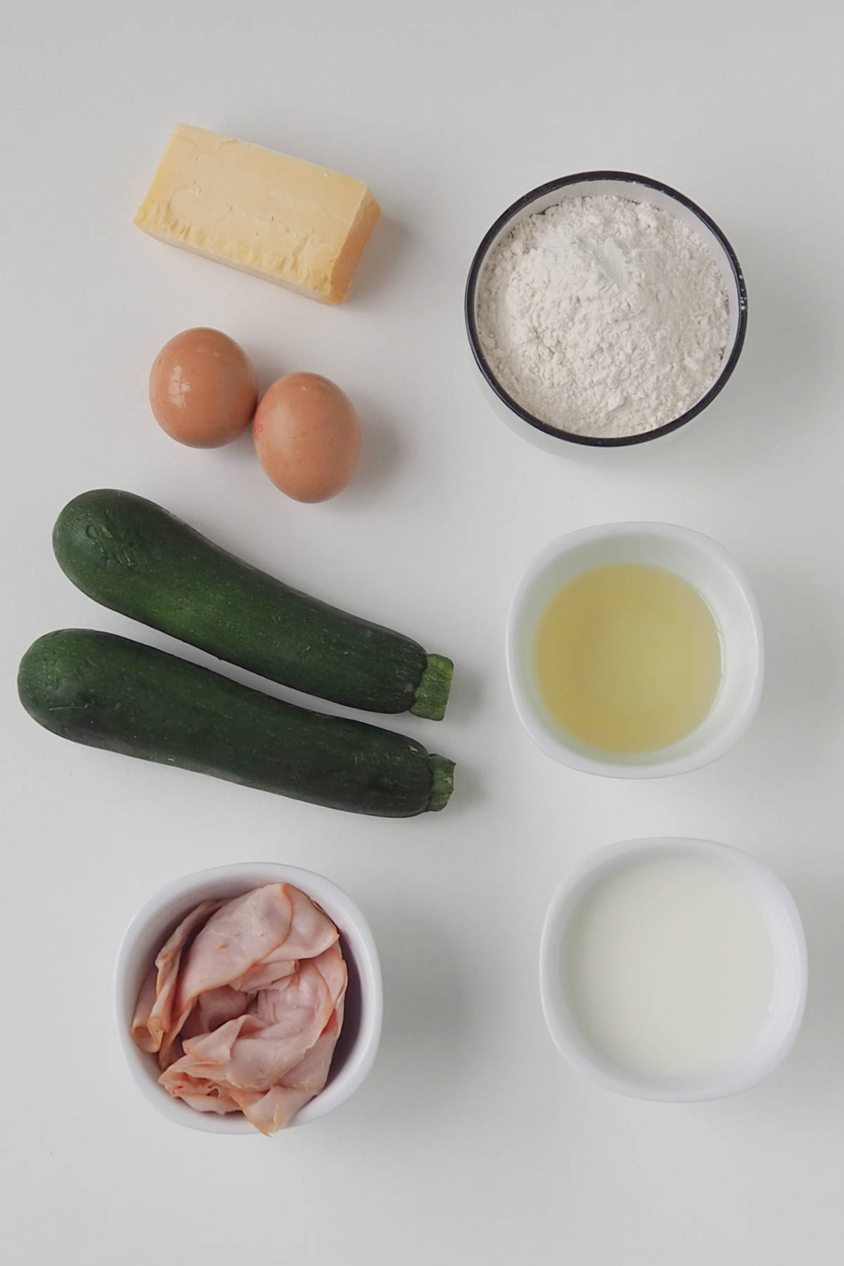 Ingredients to make Savoury Muffins in a Thermomix on a white background.